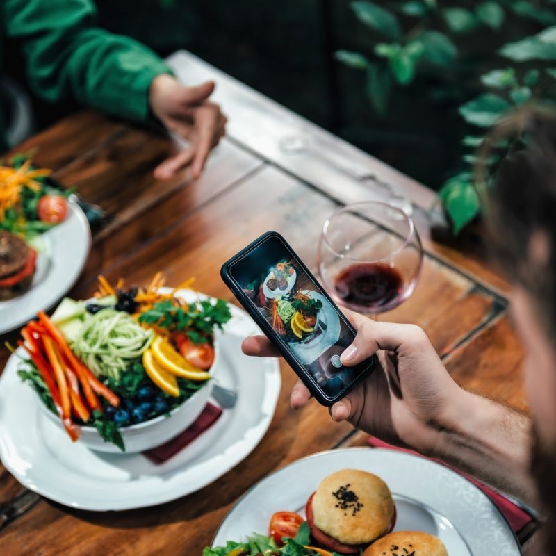 man-photographing-food-in-a-restaurant.jpg